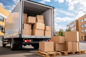 delivery truck unloading cardboard boxes in an industrial area