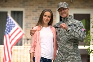 soldier and wife showing keys from new house, government social insurance