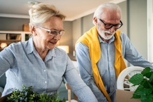senior couple packing moving boxes downsizing home