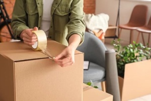 woman packing moving box at home