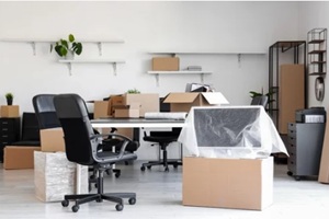 interior of light office with cardboard boxes on moving day
