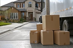 professional movers transporting boxes and belongings into a new home