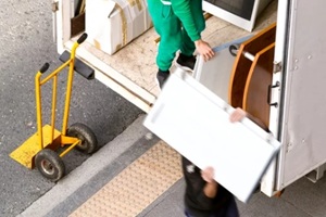 removal truck and delivery man in city street